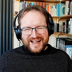 Tutor wearing headphones smiling in a small picture-in-picture window.